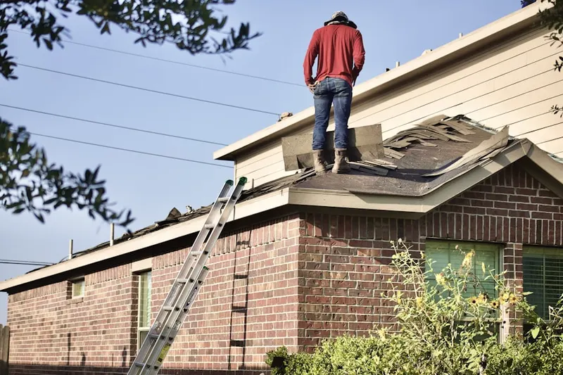 Professional roofer working on a residential roof in Buellville